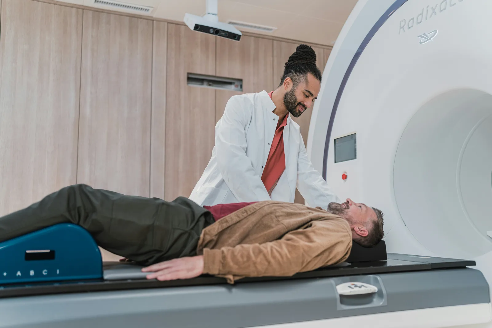 Clinician preparing a patient for a CT scan
