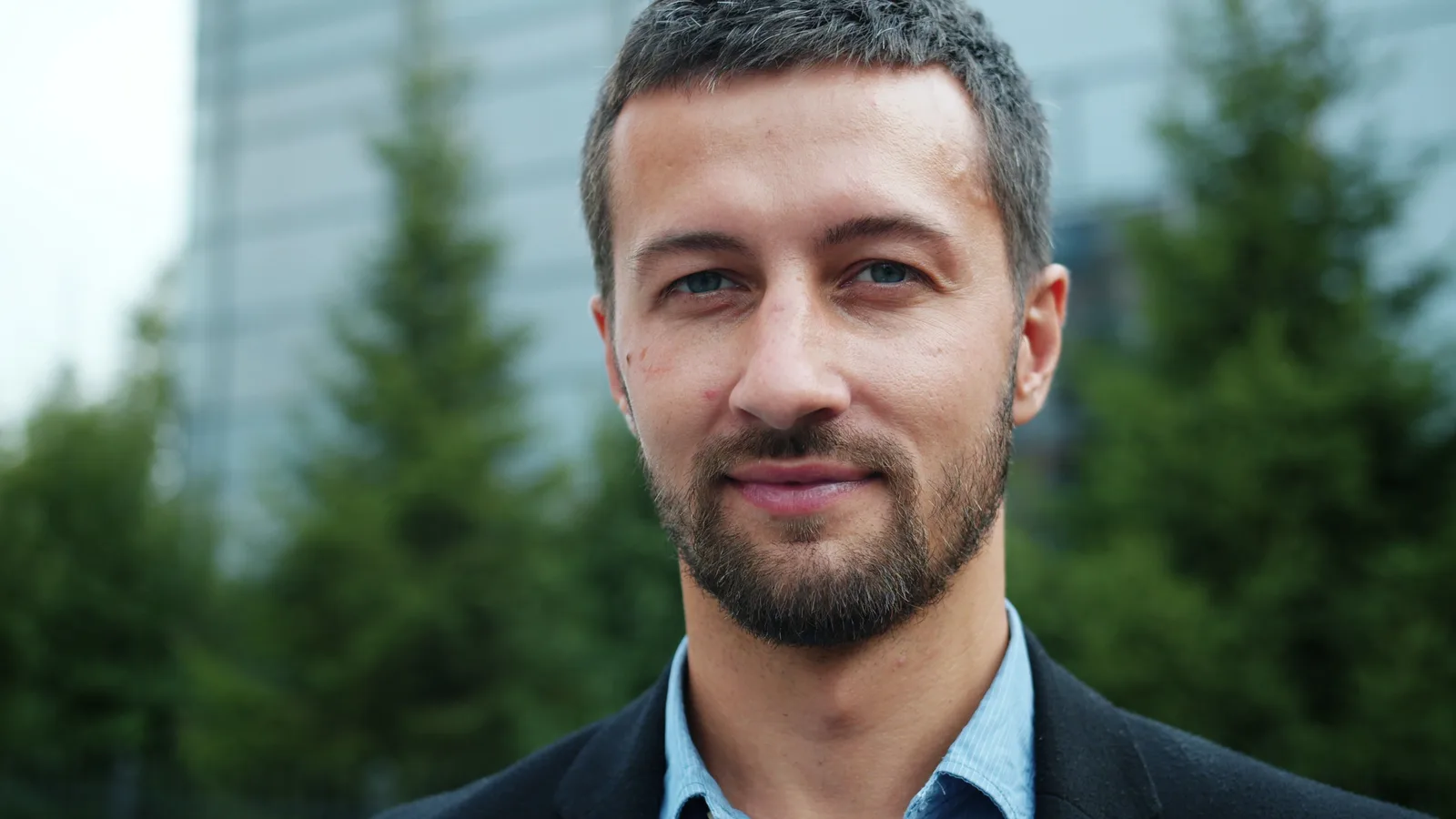 Portrait of a man outdoors with trees in the background