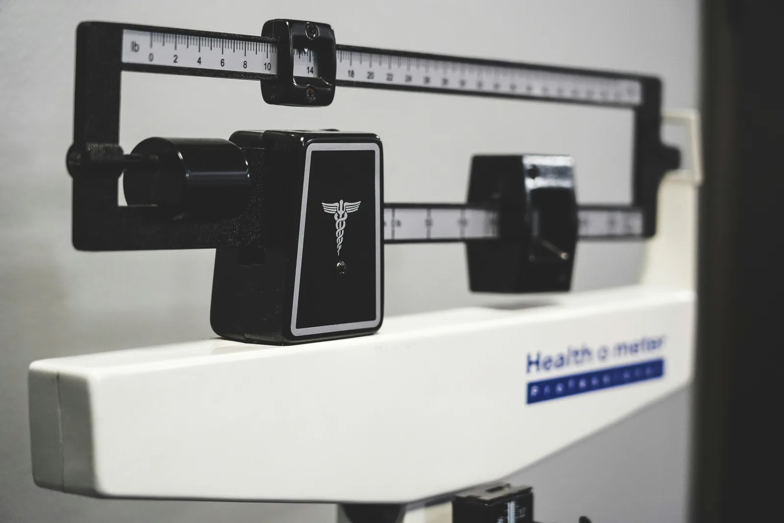 Close-up of the sliding weights on a mechanical medical scale