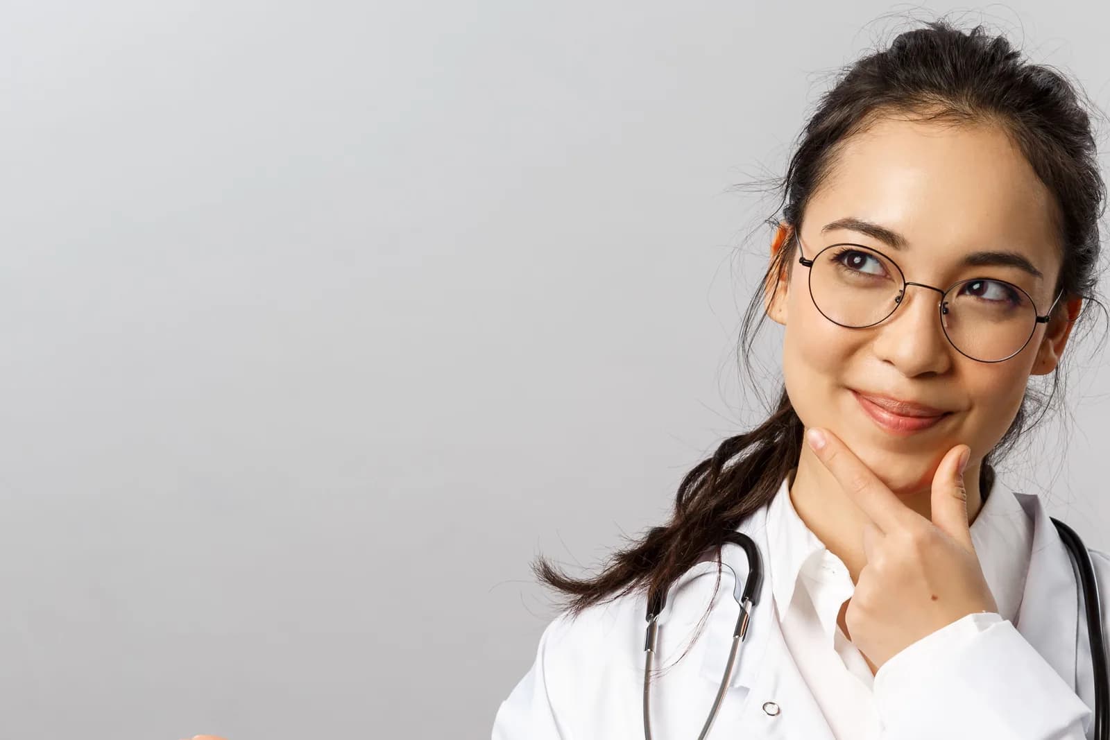 Doctor in a white coat standing in a clinical setting
