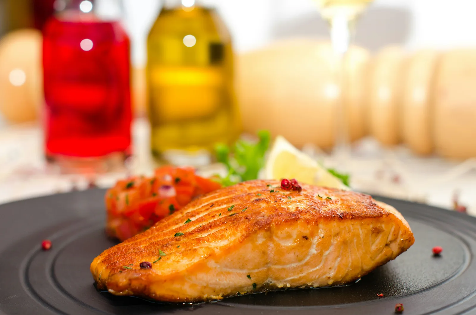Cooked fish fillet served on a dark plate