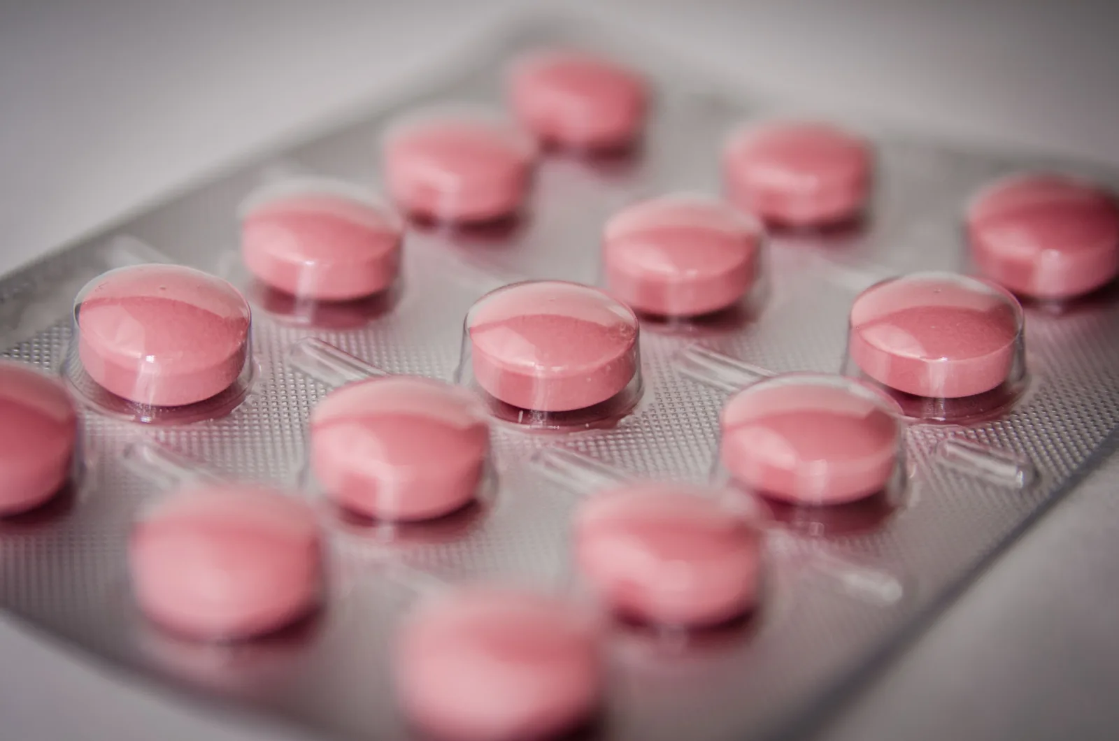 Pink round tablets sealed in a blister pack