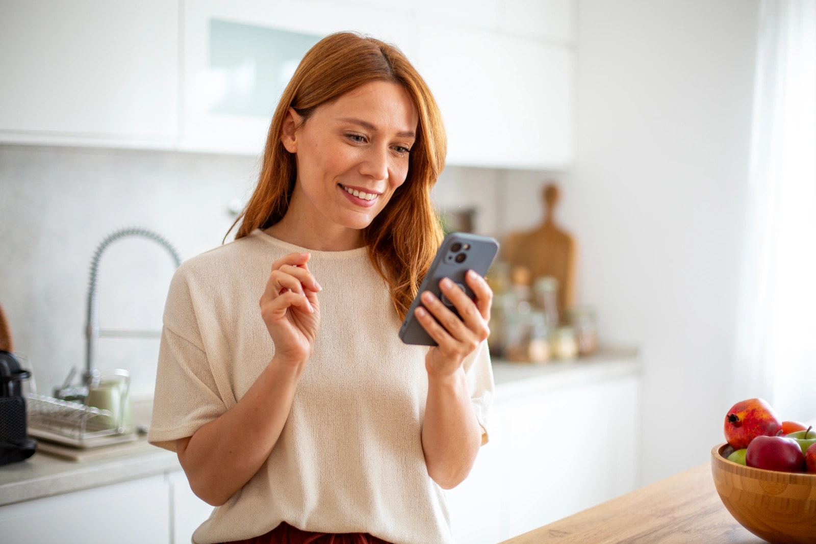 Woman using a smartphone to book a heart scan
