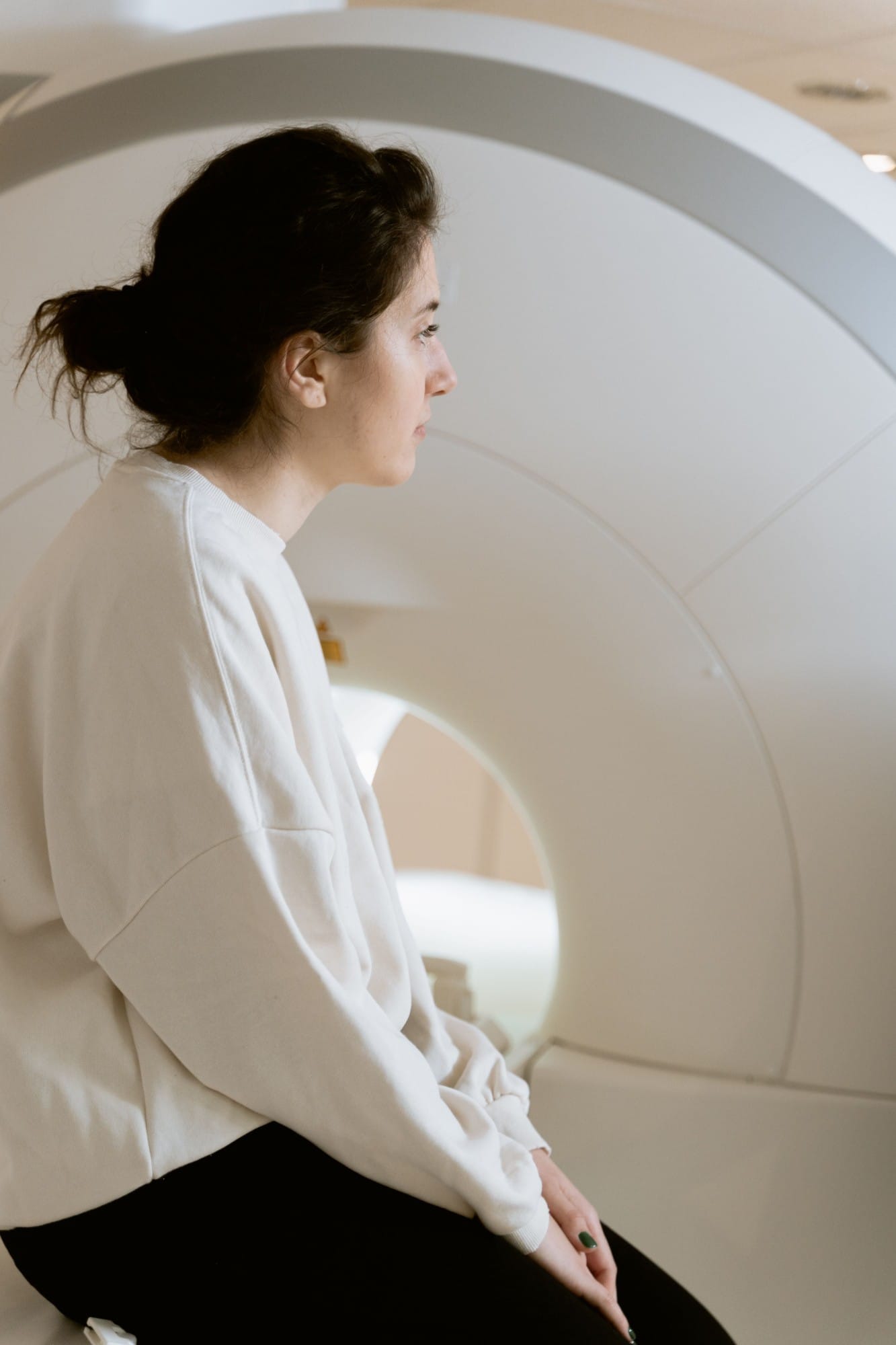 Woman sitting on a scanner table
